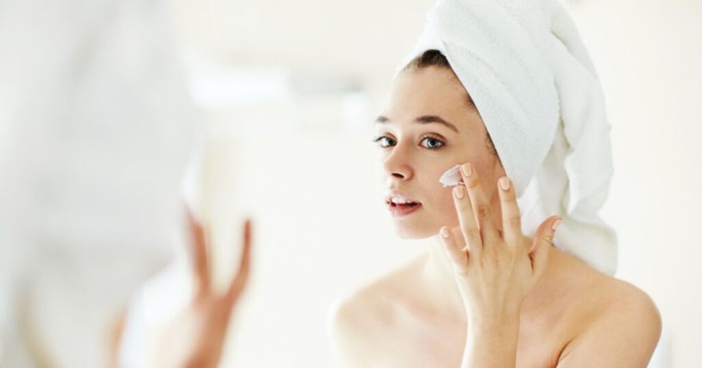 A woman embracing natural sunshine, representing freedom from the sunscreen advertisements trap.